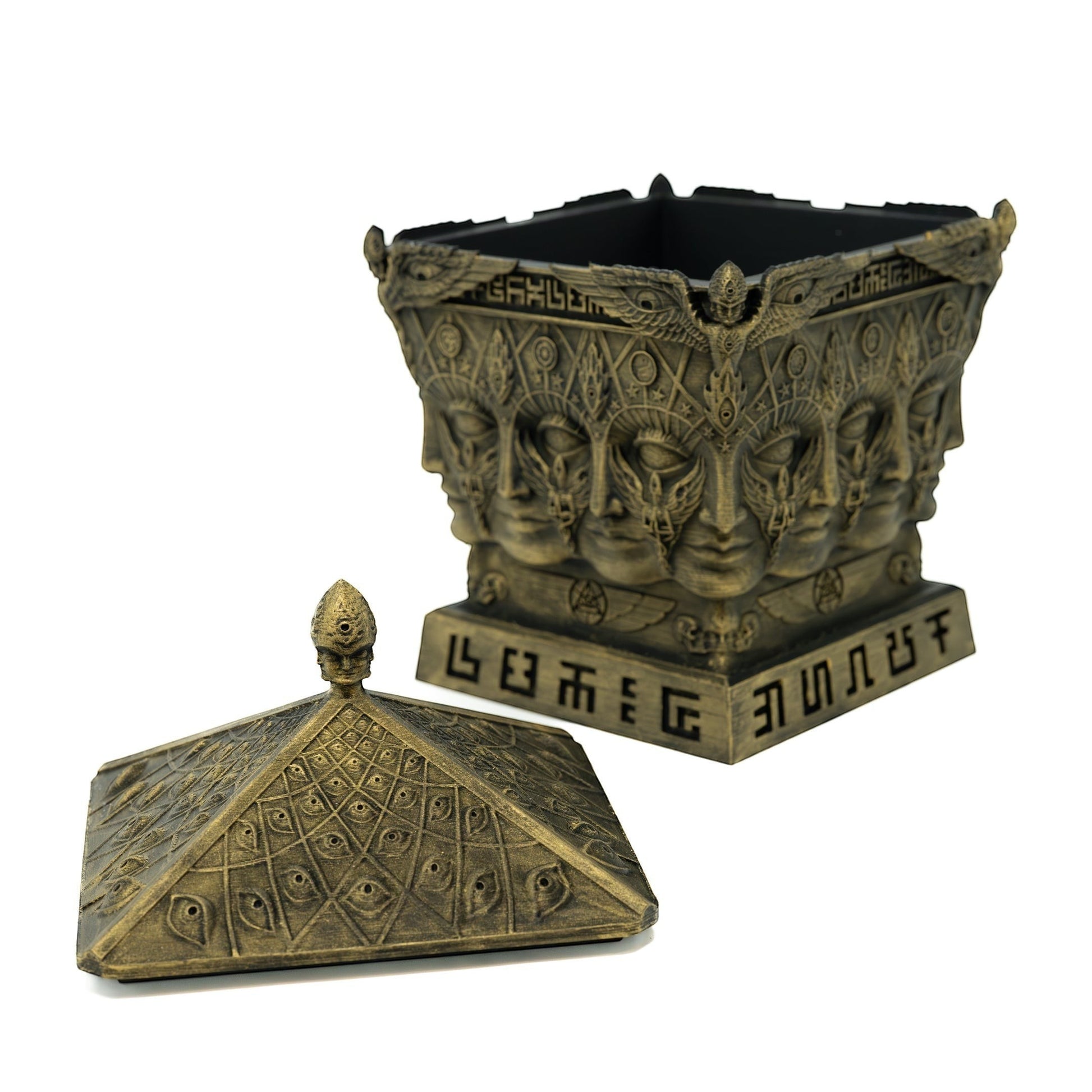 CoSM Shop Entheon Prayer Box, a hand-painted bronze sculpture featuring multiple faces and symbolic designs. Includes a pyramid lid adorned with eyes.