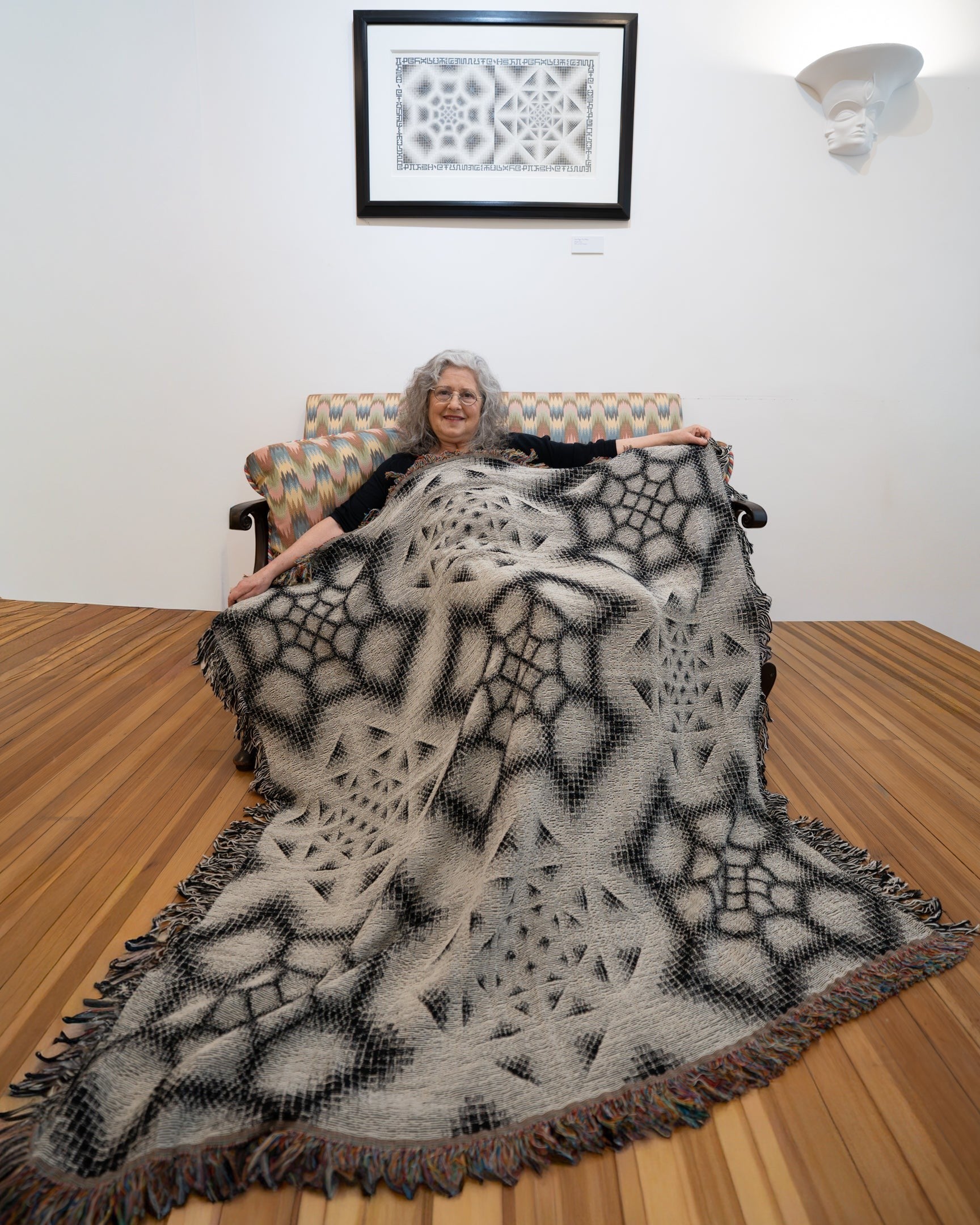CoSM Shop Inkwash art blanket with a geometric grey scale pattern, made of recycled cotton.