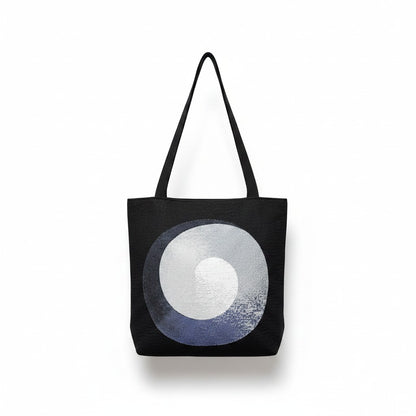CoSM Shop Polar Unity Spiral woven tote bag with black handles and tapestry art on both sides.