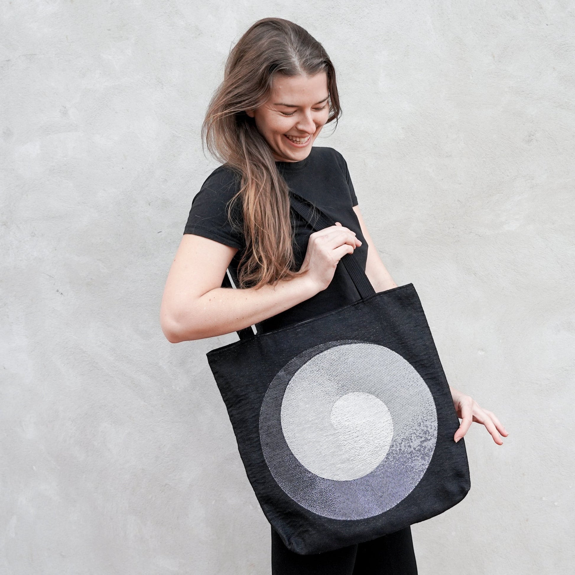 CoSM Shop black woven tote bag with Alex Grey's Polar Unity Spiral artwork in white and grey tones.
