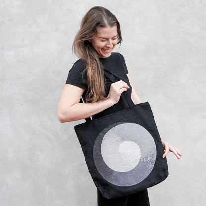 CoSM Shop black woven tote bag with Alex Grey's Polar Unity Spiral artwork in white and grey tones.