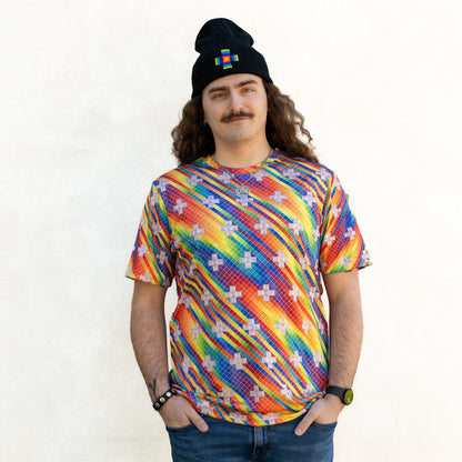 CoSM Shop men's short-sleeve performance polyester t-shirt with a rainbow spectral rain dye-sub print and white cross pattern.