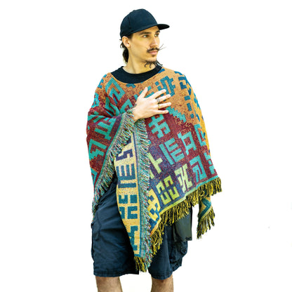 CoSM Shop Secret Writing Blend poncho featuring Allyson Grey artwork, woven from 100% recycled cotton on a model.