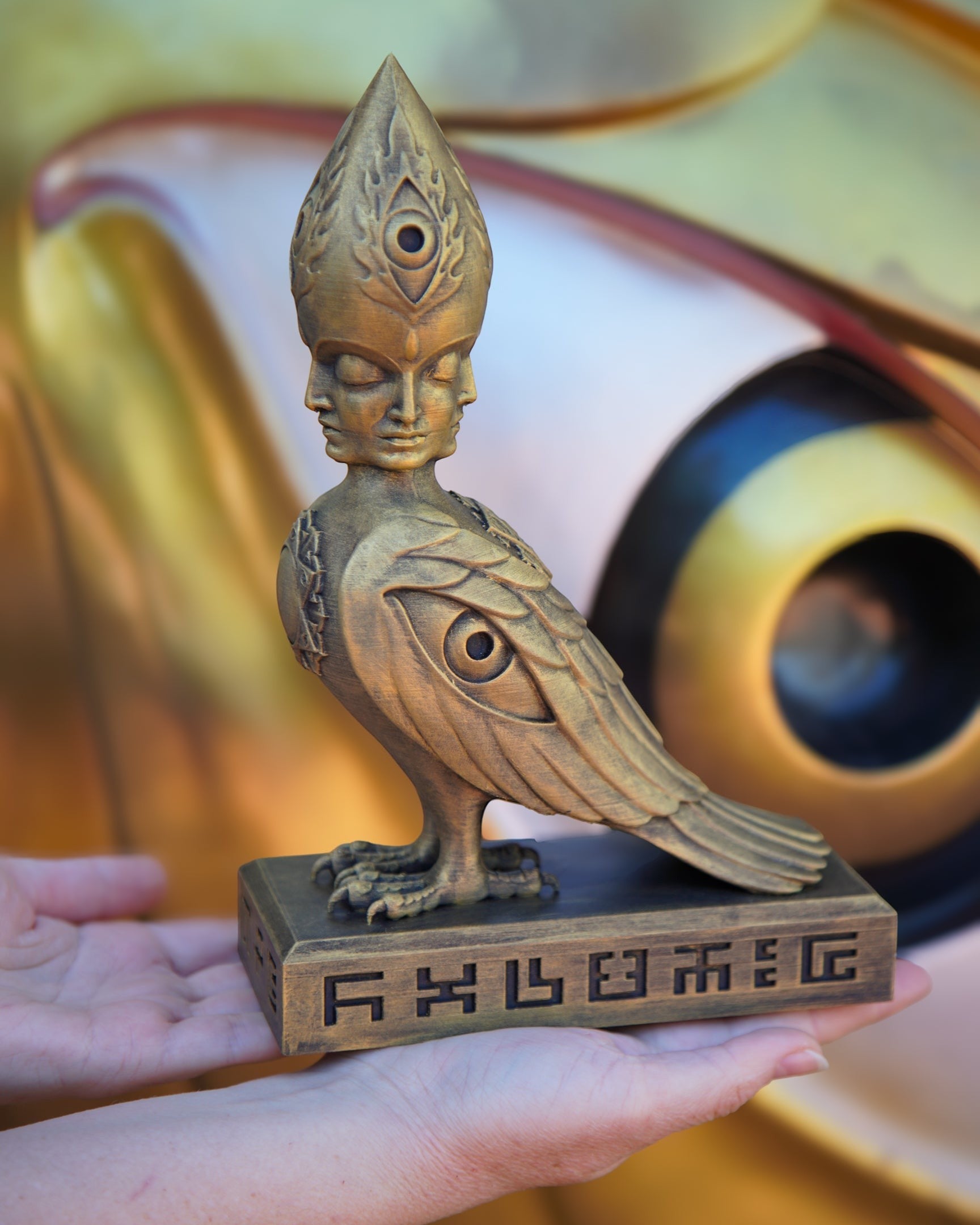 CoSM Shop Soulbird sculpture by Alex Grey, hand-painted gold bird with four faces and third eye, 10" limited edition