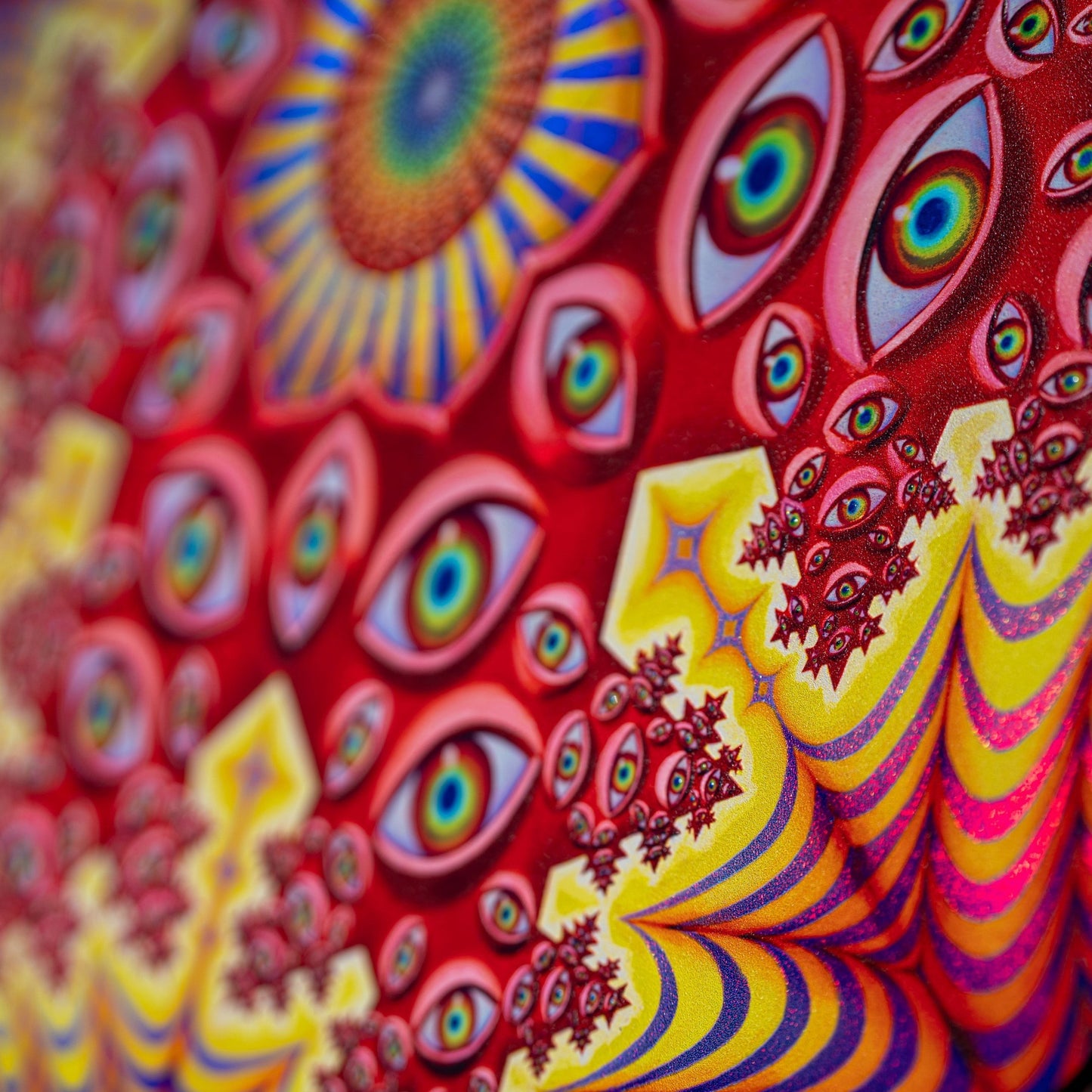 CoSM Shop Vision Crystal Tondo holographic textured metal print featuring numerous eyes and fractal patterns in red, yellow, and purple.