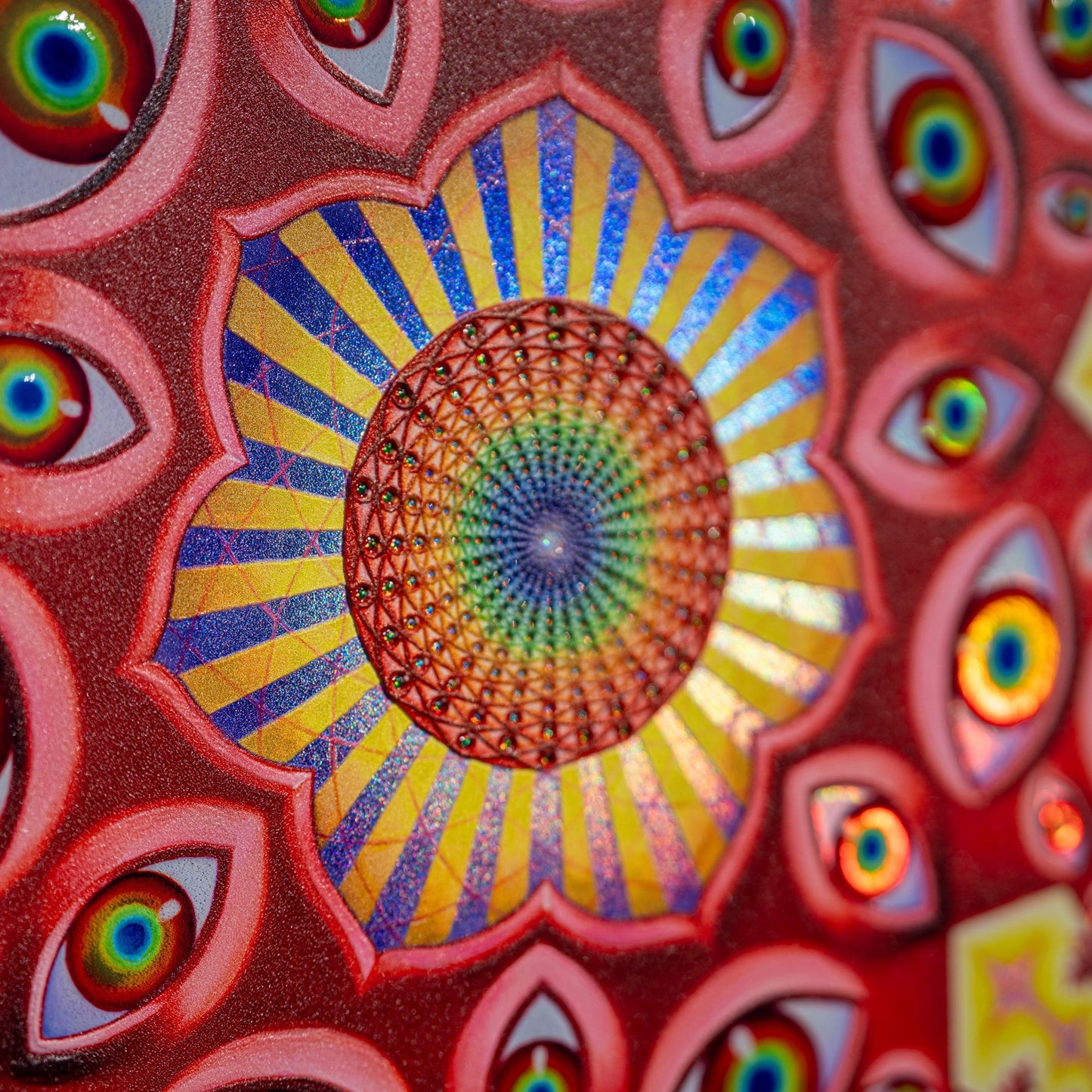 CoSM Shop Vision Crystal Tondo holographic textured metal print featuring a central mandala of eyes and radiating patterns in red, blue, and yellow.