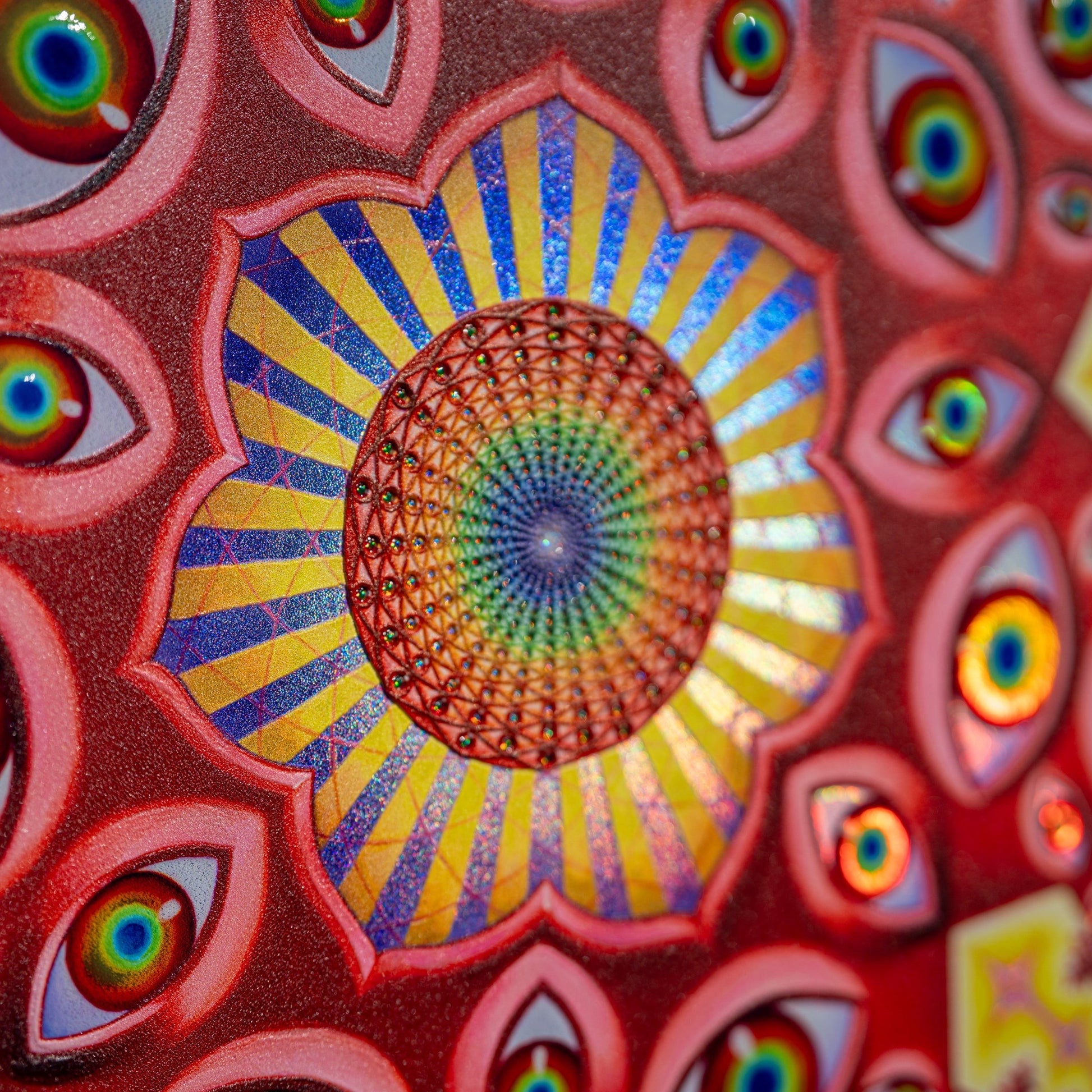 CoSM Shop Vision Crystal Tondo holographic textured metal print featuring a central mandala of eyes and radiating patterns in red, blue, and yellow.