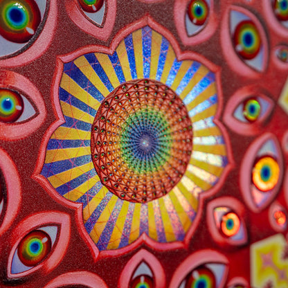 CoSM Shop Vision Crystal Tondo holographic textured metal print featuring a central mandala of eyes and radiating patterns in red, blue, and yellow.